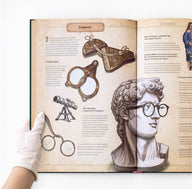 Illustrated eyeglasses spread inside The Codex: Inventions of the Human Mind, showing the history of spectacles, lenses, optical devices, and invention design
