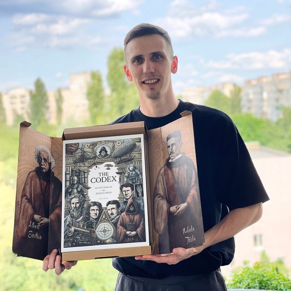 Reader holding The Codex: Inventions of the Human Mind premium illustrated hardcover book with gift box packaging and collector edition artwork outdoors